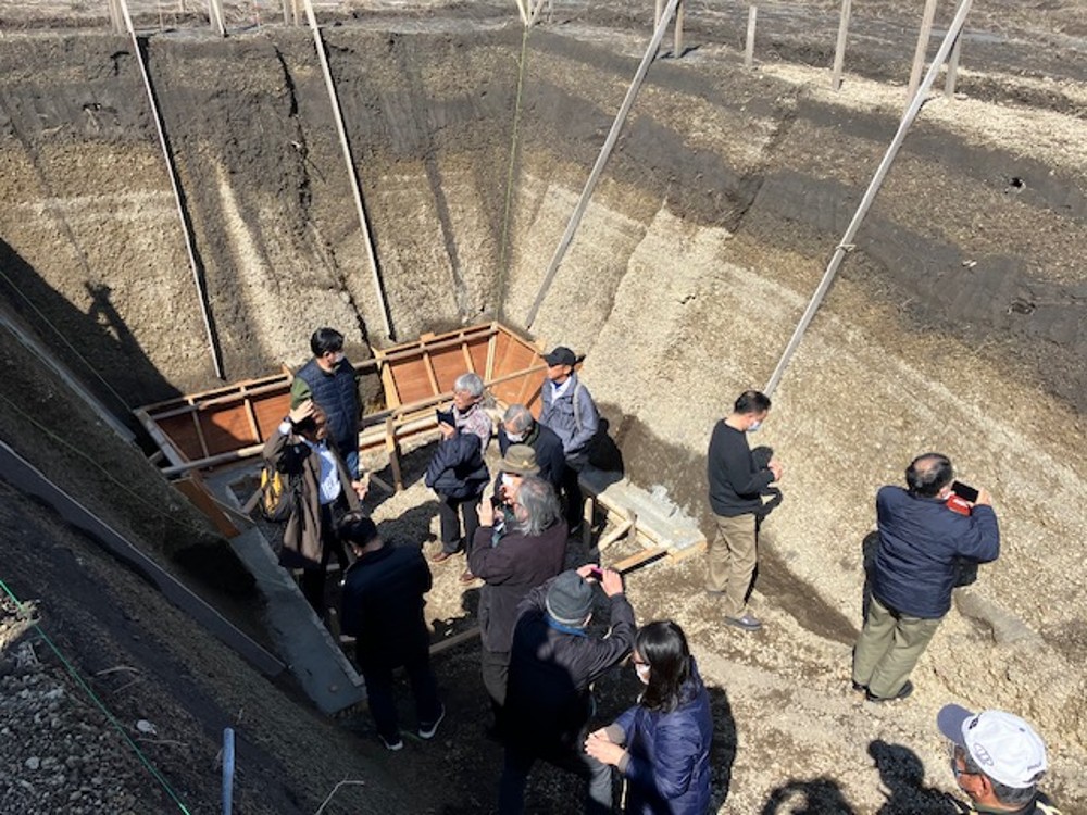 Local residents observing the Sakurajima pumice deposit trench