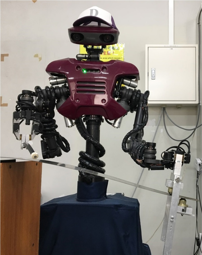 A humanoid robot manipulating a musical saw